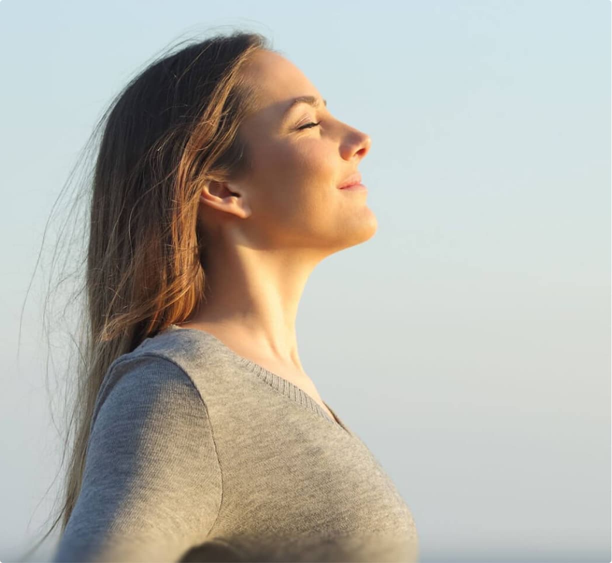 Woman breathing deeply outdoors